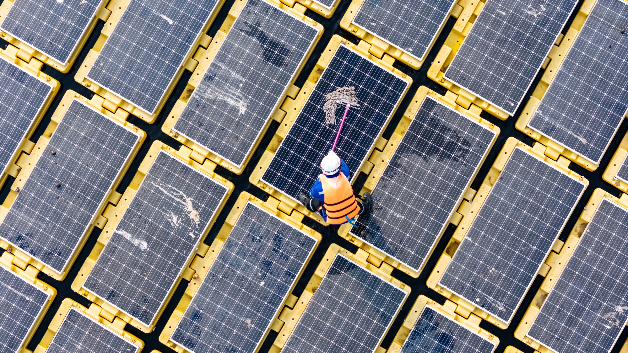 Men technicians mounting photovoltaic solar at floating solar station